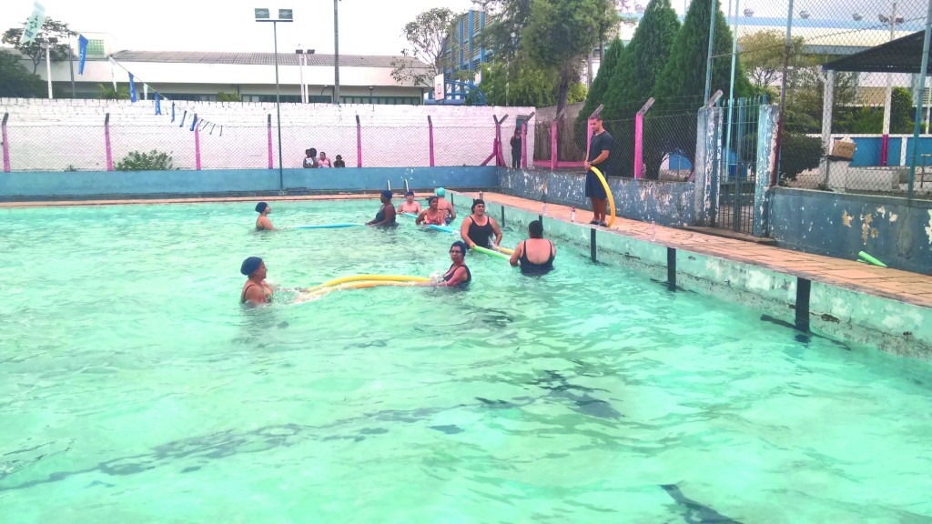 Senhoras participam de aula de hidroginástica na piscina da Escola Superior; atividade é orientada por universitários do Departamento de Esportes (Assessoria  / DEC)