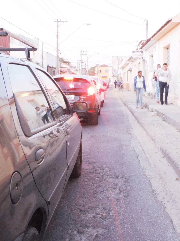 Carros enfileirados na rua Padre João Renaudin, principal acesso à rodoviária; cidade tenta se organizar (Foto: Rafaela Lourenço) 