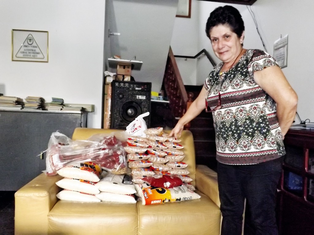 Alcione Ferreira mostra alimentos recuperados após ação de criminosos na Casa do Amigo, em Cachoeira (Foto: Lucas Barbosa)